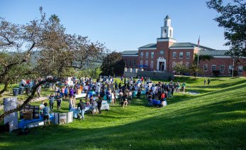 green hills and large brick buildings