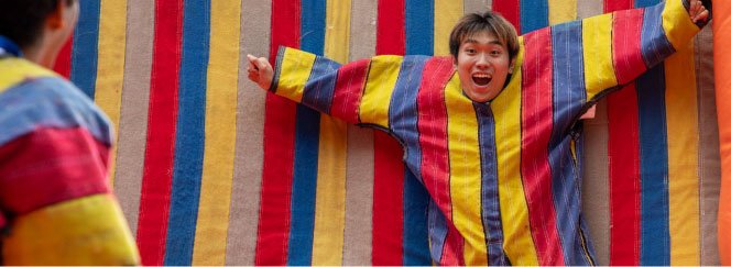 student stuck to velcro wall